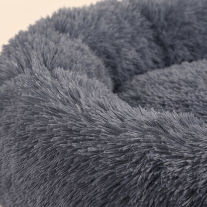 Close-up of the soft dark-gray faux-fur and raised cuddler rim of the Joobello calming donut dog bed