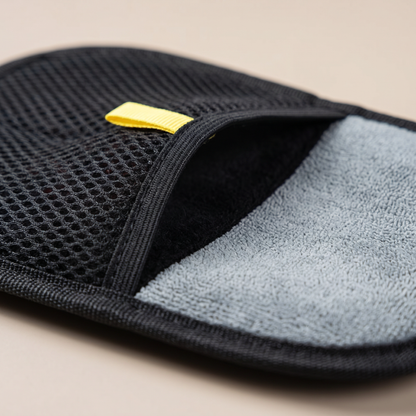 Close-up of the Joobello two-sided grooming glove black mesh side and soft gray microfiber side