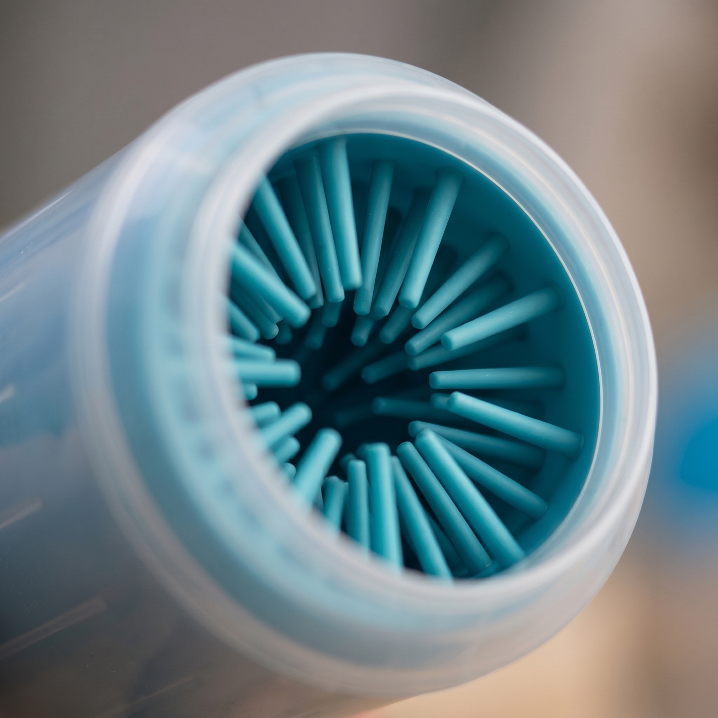 Close-up inside the Joobello paw cleaner cup showing the soft silicone cleaning bristles