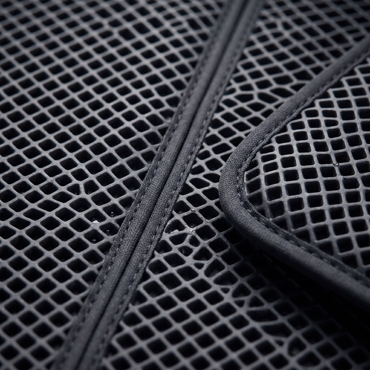 Macro of the Joobello waterproof pet mat raised diamond-honeycomb textured surface and edge binding